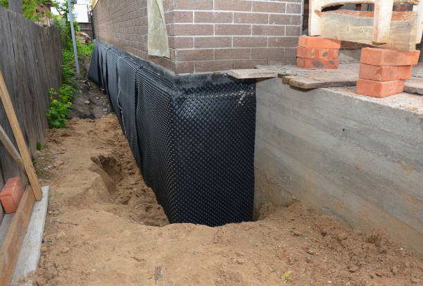SJ Waterproofing Pros technician performing targeted Wet Basement Repair assessment in Troy, OH